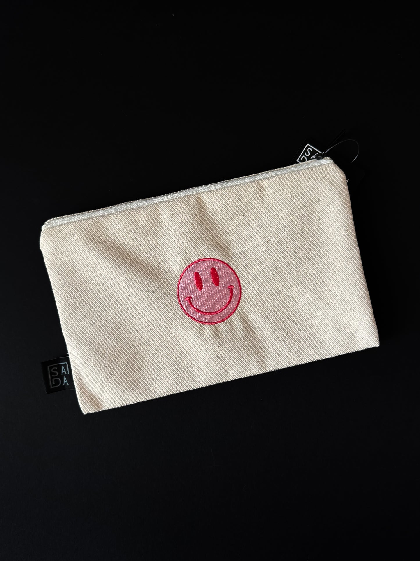 pink smiley face pouch